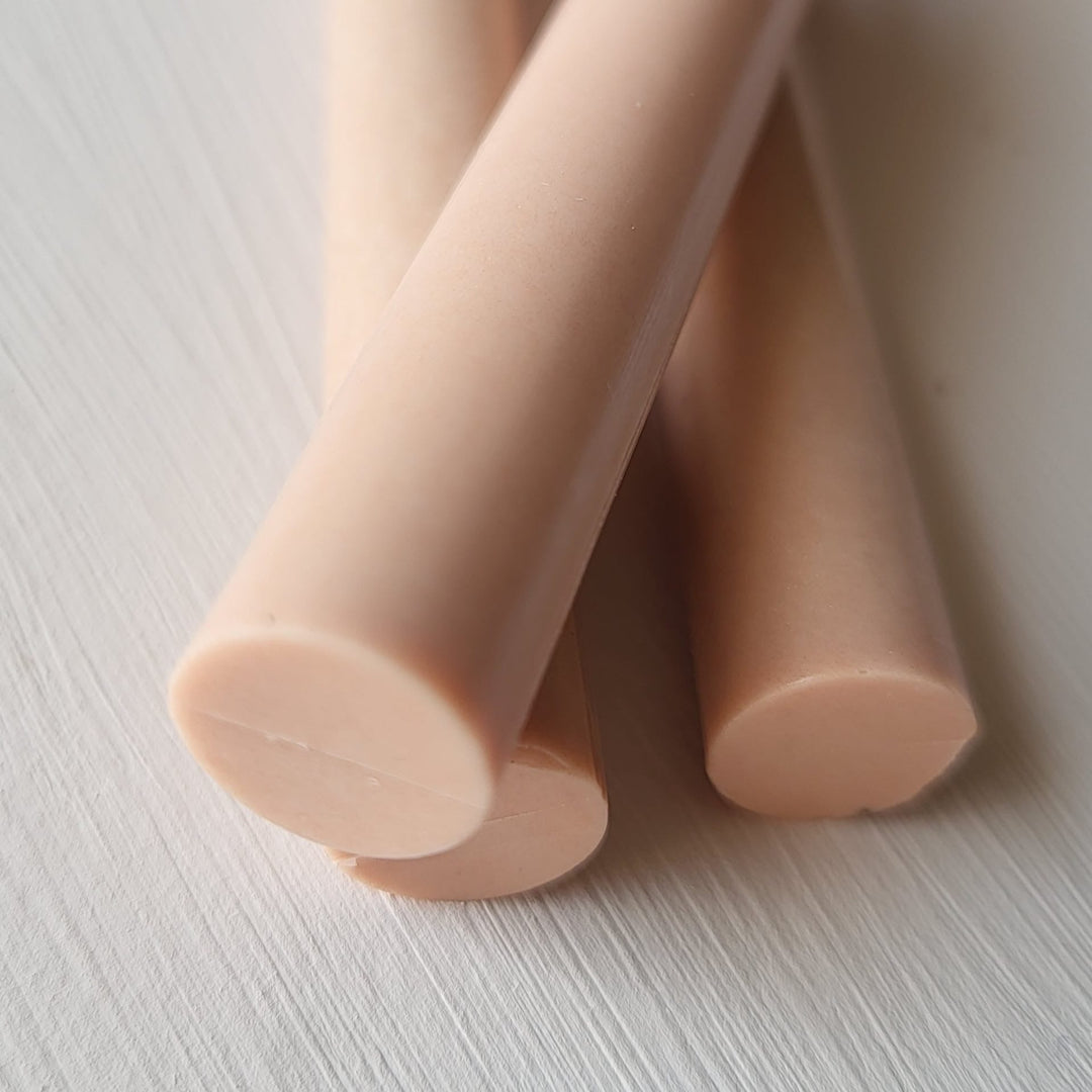 Close-up of seashell-colored 11mm sealing wax sticks from a pack of 10, ideal for arts and crafts projects like wax seals.