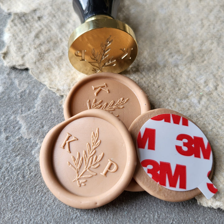 Peach 'Willow' monogram wax seals with initials 'K' and 'P,' shown with a matching brass stamp and 3M adhesive backing.