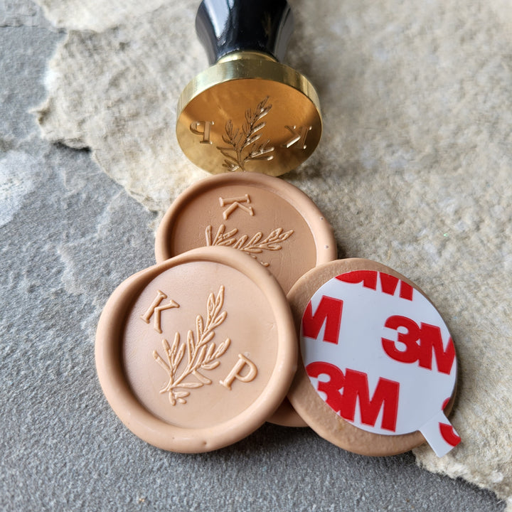 Peach 'Willow' monogram wax seals with initials 'K' and 'P,' paired with a brass stamp and 3M adhesive backing for easy application.