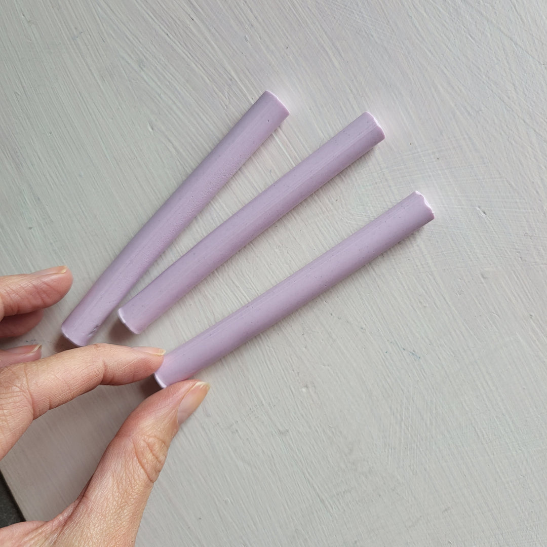 Three lilac-colored 11mm sealing wax sticks from a 10-pack, ideal for crafting and office use, displayed on a light surface.