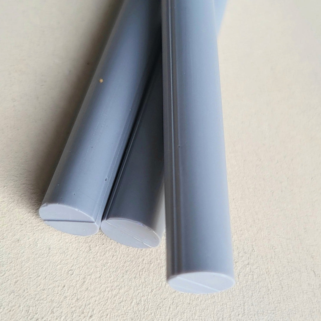 Close-up of lavender grey 11mm sealing wax sticks, smooth finish, ideal for arts and crafts projects. Pack of 10 for creative use.