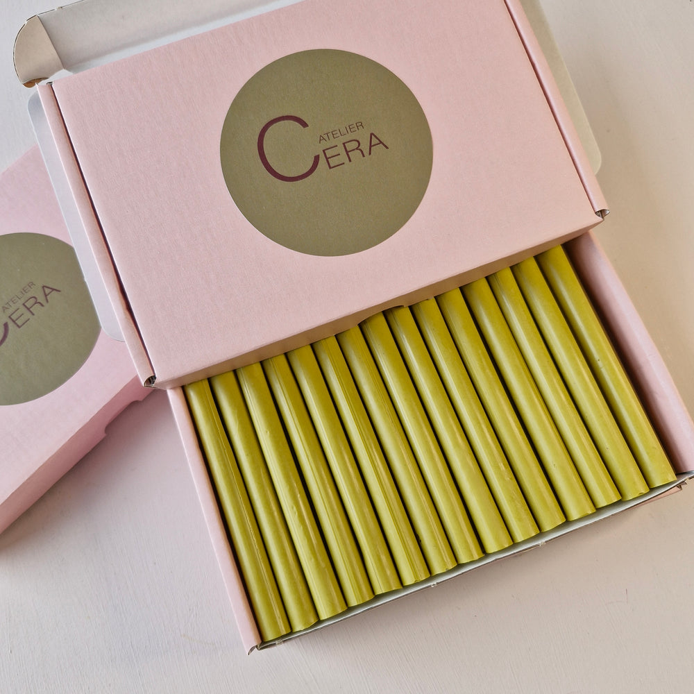 Close-up of a box containing 30 lagoon-colored 11mm x 100mm sealing wax sticks, neatly arranged in pink Atelier Cera packaging.