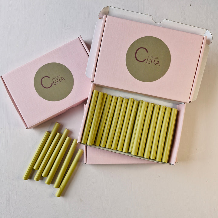 Box of 30 handmade 11mm x 100mm sealing wax sticks in lagoon color, displayed in pink packaging with Atelier Cera branding.