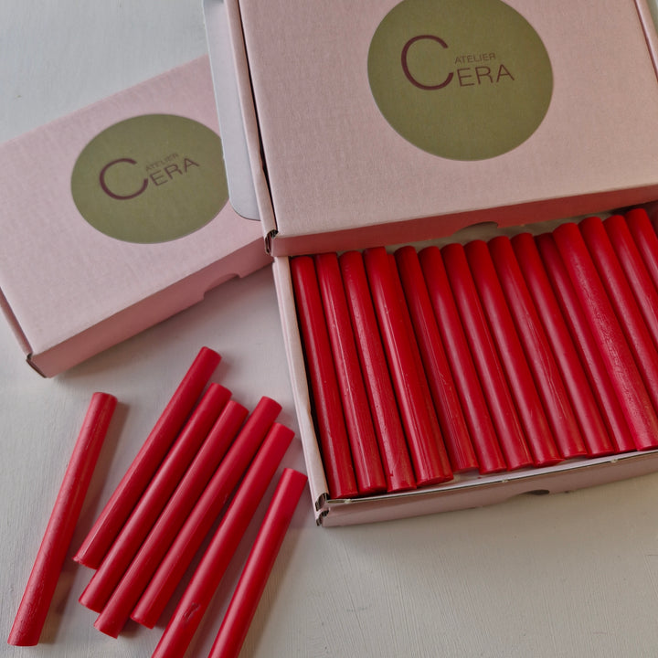 Box of 30 handmade 11mm raspberry red wax sealing sticks displayed in an open pink box with Atelier Cera branding.