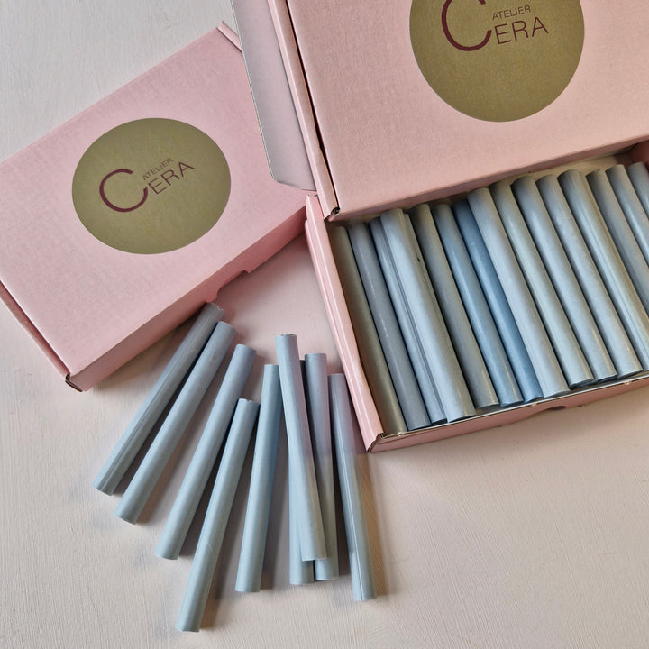 Open box of French Blue 11mm sealing wax sticks with some sticks displayed outside. Ideal for wax seals and creative projects.