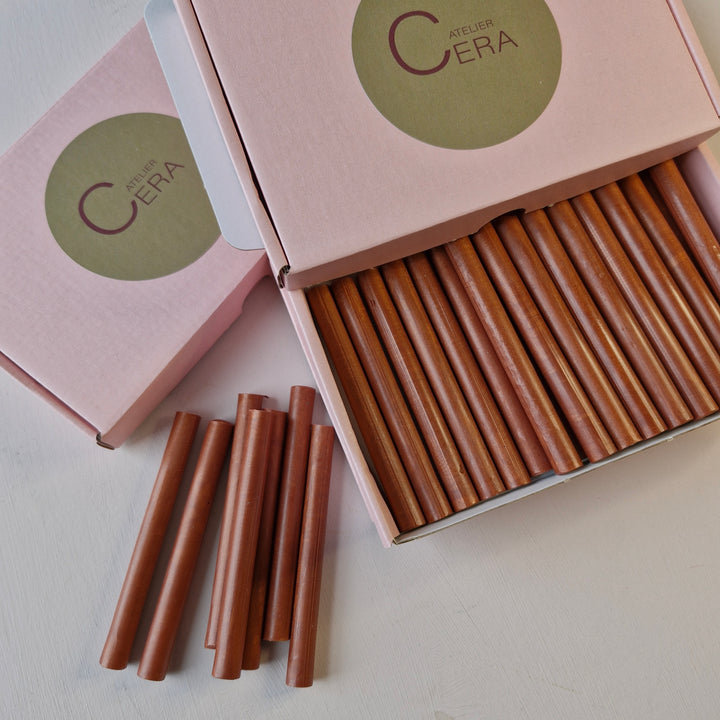 Open pink box containing 30 copper wax sticks, with a few sticks placed outside. Perfect for handmade sealing projects.