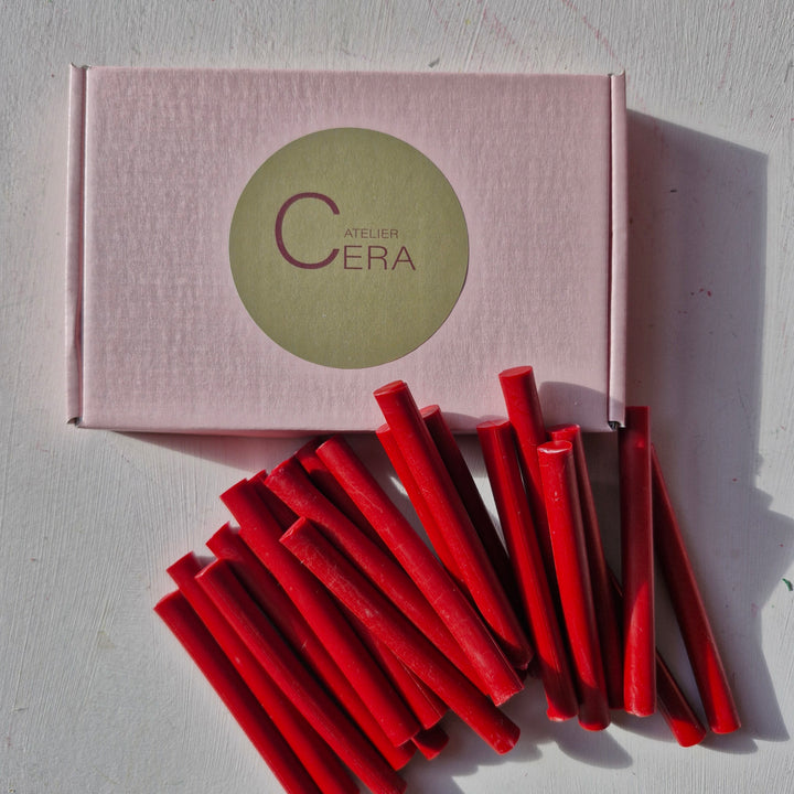 Classic red 11mm sealing wax sticks arranged beside a branded box. Perfect for sealing documents and decorative purposes.