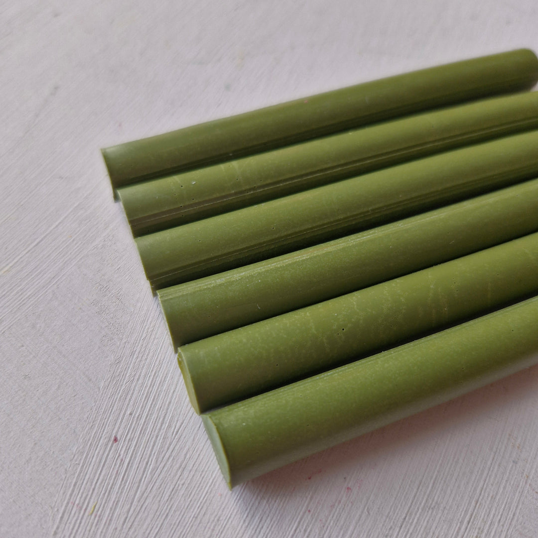 Set of 11mm olive green office sticks in a box of 50, ideal for crafting and office use. Durable and versatile for various applications.