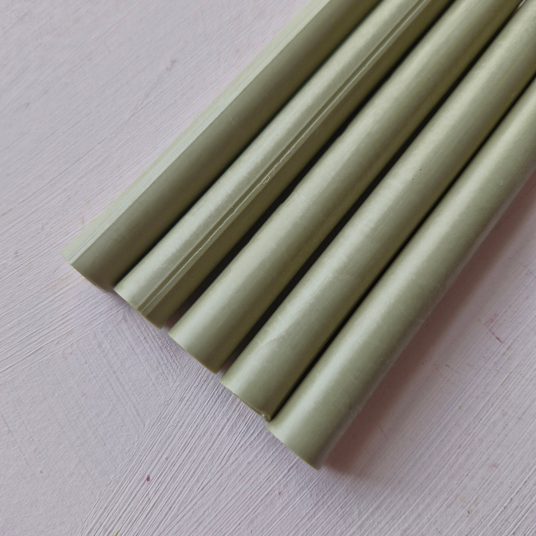 Close-up of 11mm pistachio-colored office instrument sticks from a box of 50, ideal for crafting and office use.