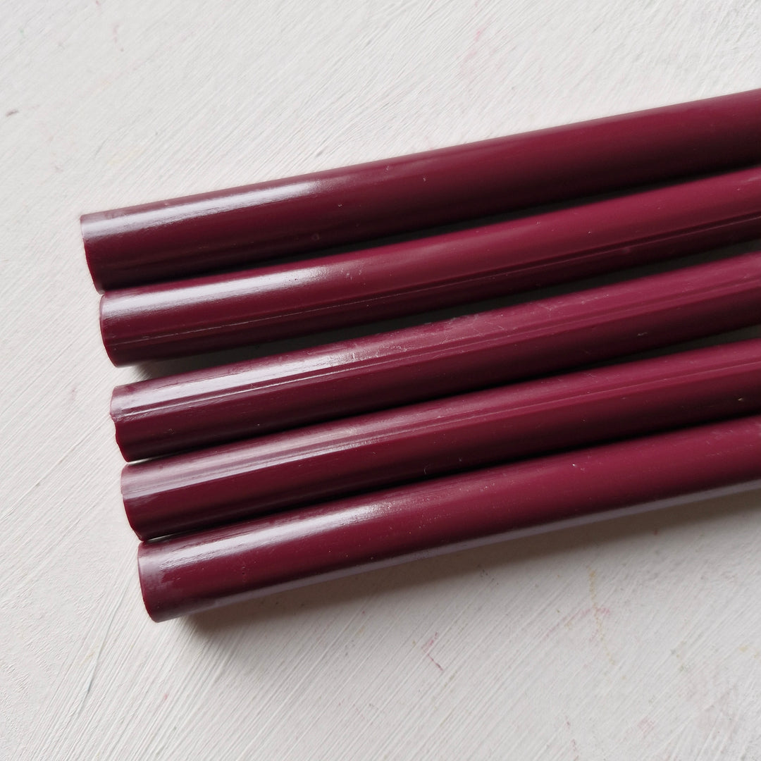 Close-up of 11mm burgundy wax sticks from a box of 50, ideal for premium sealing and crafting projects.