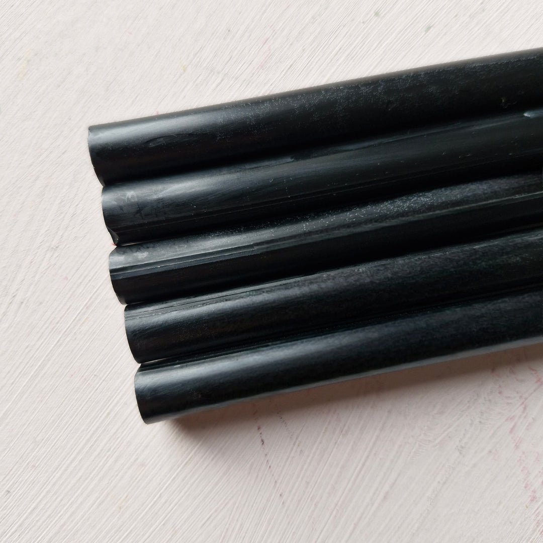 Close-up of black 11mm office instrument rods, part of a box of 50, ideal for office and crafting needs.