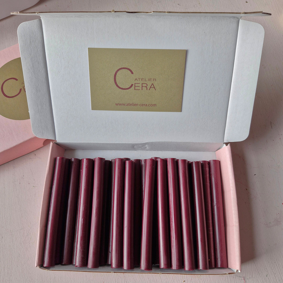 Open box displaying 500 burgundy 11mm sealing wax sticks neatly arranged, ideal for office supplies and crafting needs.