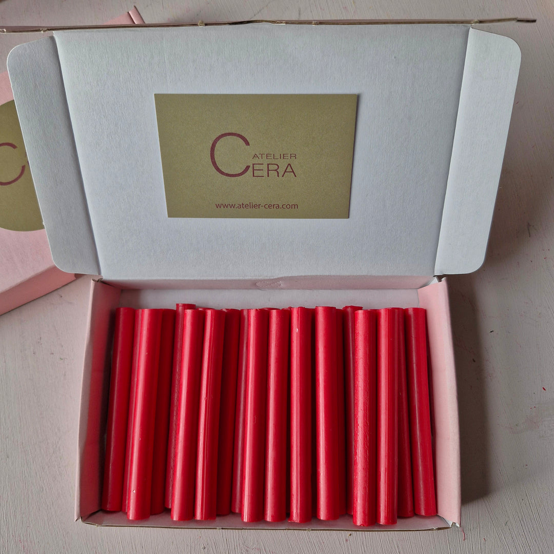 Box of 500 x 11mm raspberry red sealing wax sticks neatly arranged for office and crafting use. Ideal for sealing envelopes and documents.