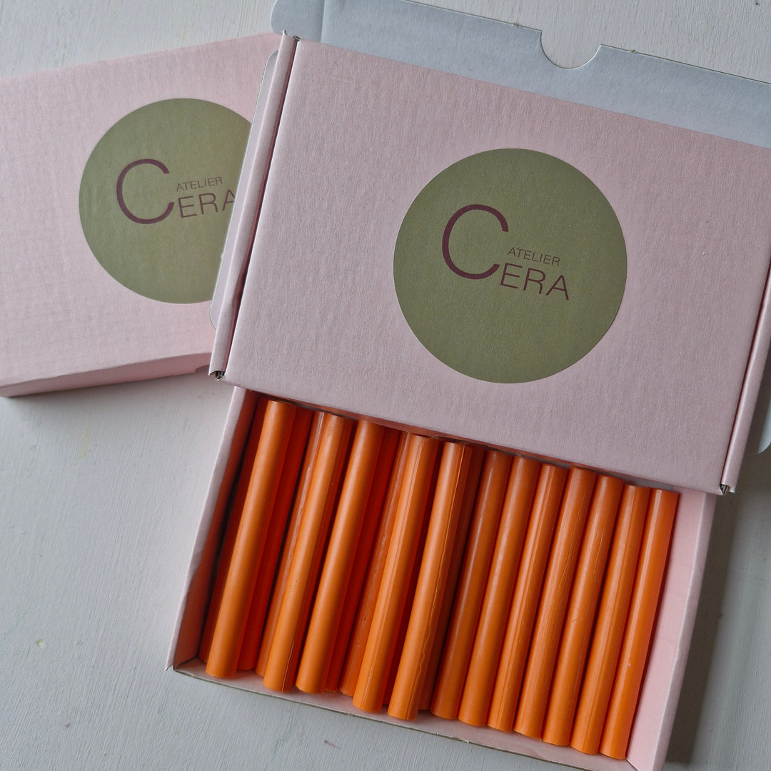 Box of 30 handmade 11mm tangerine sealing wax sticks displayed in pink packaging. Ideal for sealing envelopes and crafts.