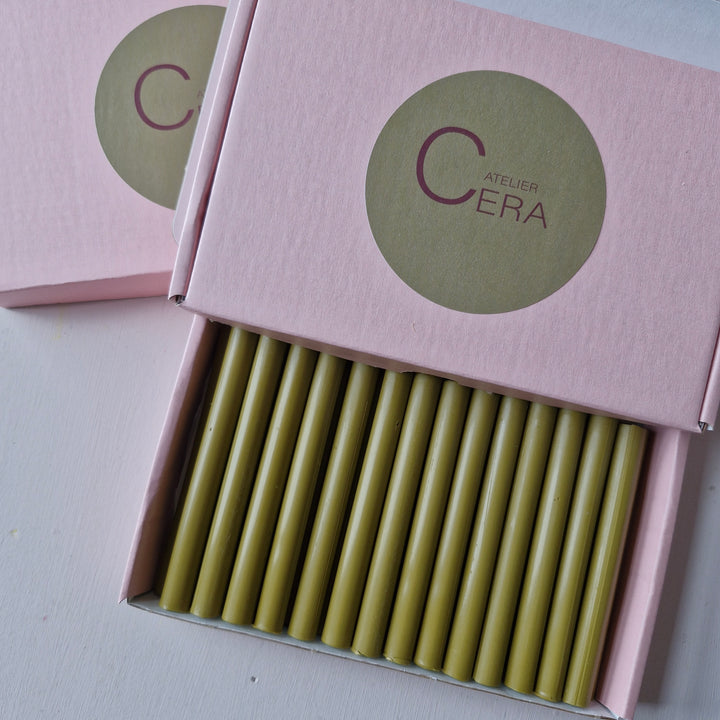 Open box of 30 Dijon-colored 11mm handmade sealing wax sticks in pink packaging, perfect for office supplies and creative projects.