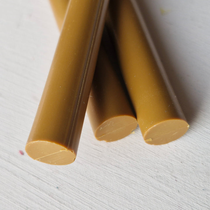 Handmade toffee-colored sealing wax sticks, 11mm diameter, displayed on a white background for crafting and office use.