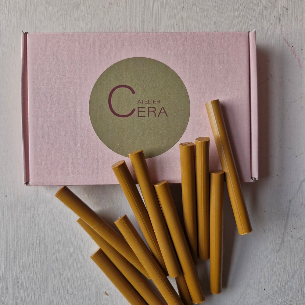 Toffee-colored 11mm sealing wax sticks displayed in front of a pink Atelier Cera branded box.