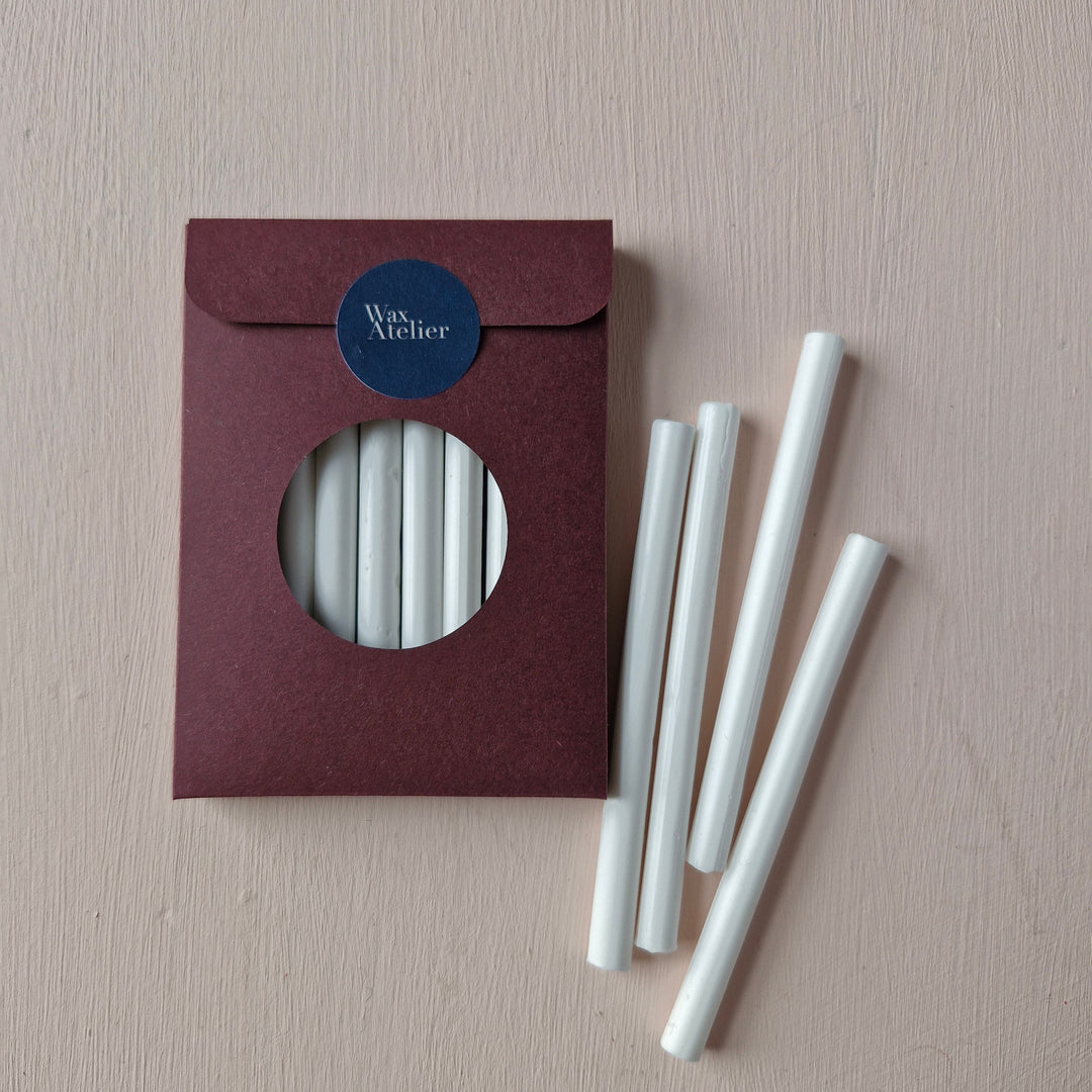 Pack of 10 Chelsea White 7mm sealing wax sticks with a burgundy envelope-style package. Ideal for wax seals on invitations and envelopes.