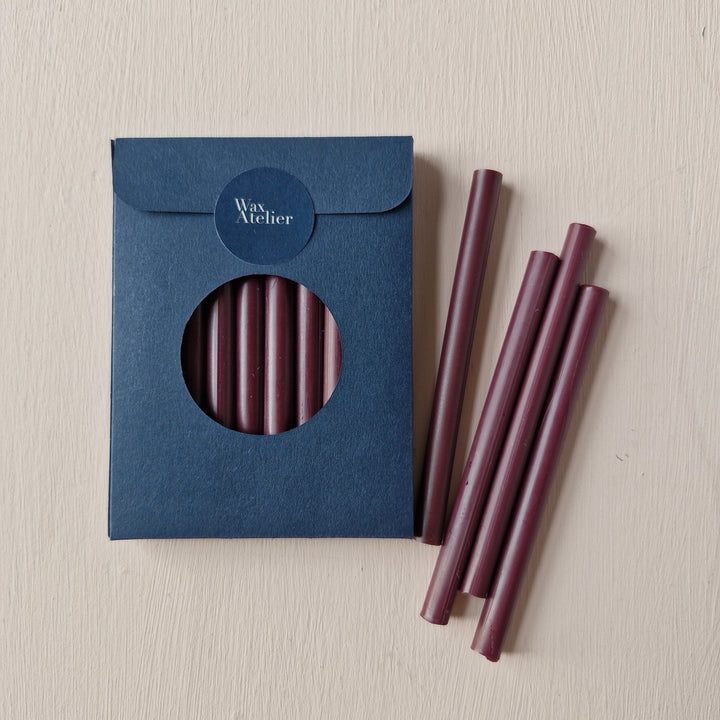 Pack of 10 burgundy 7mm sealing wax sticks with a navy blue box. Ideal for creating up to 50 seals, perfect for envelopes and invitations.