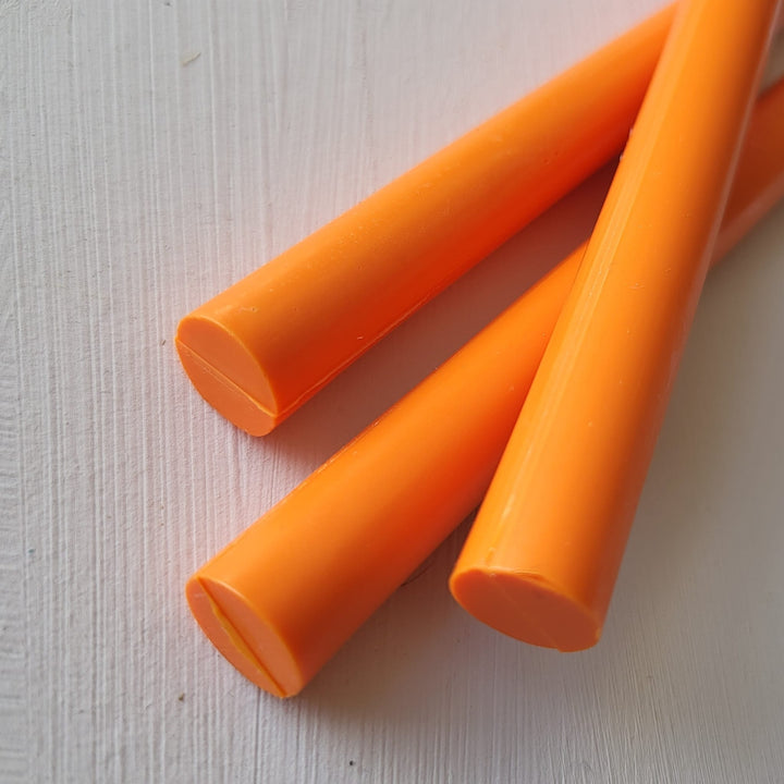 Three vibrant tangerine 11mm sealing wax sticks displayed on a white surface, part of a 10-pack for office and creative projects.