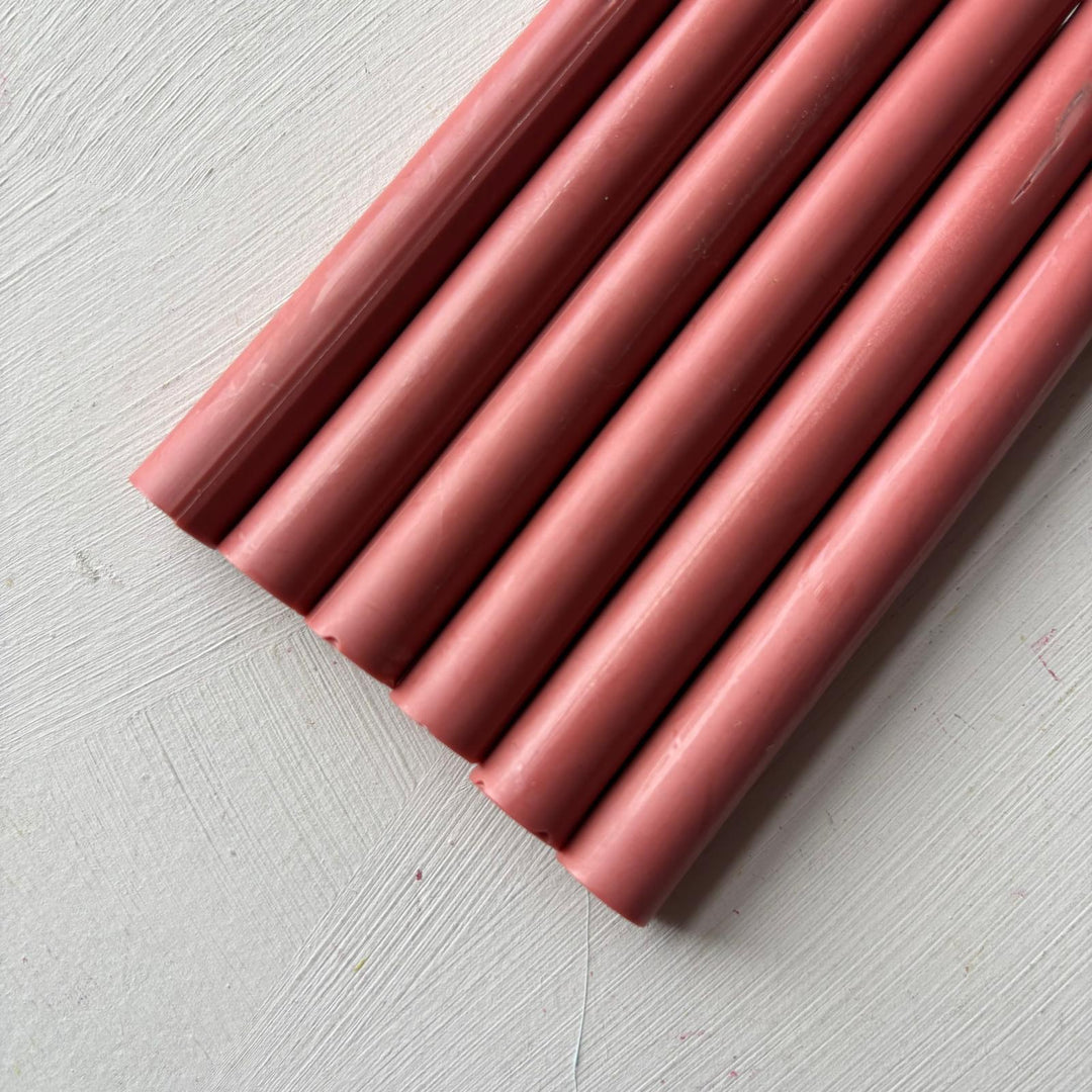 Box of 50 - 11mm Antique Pink wax sticks arranged on a textured white surface. Ideal for sealing and crafting projects.