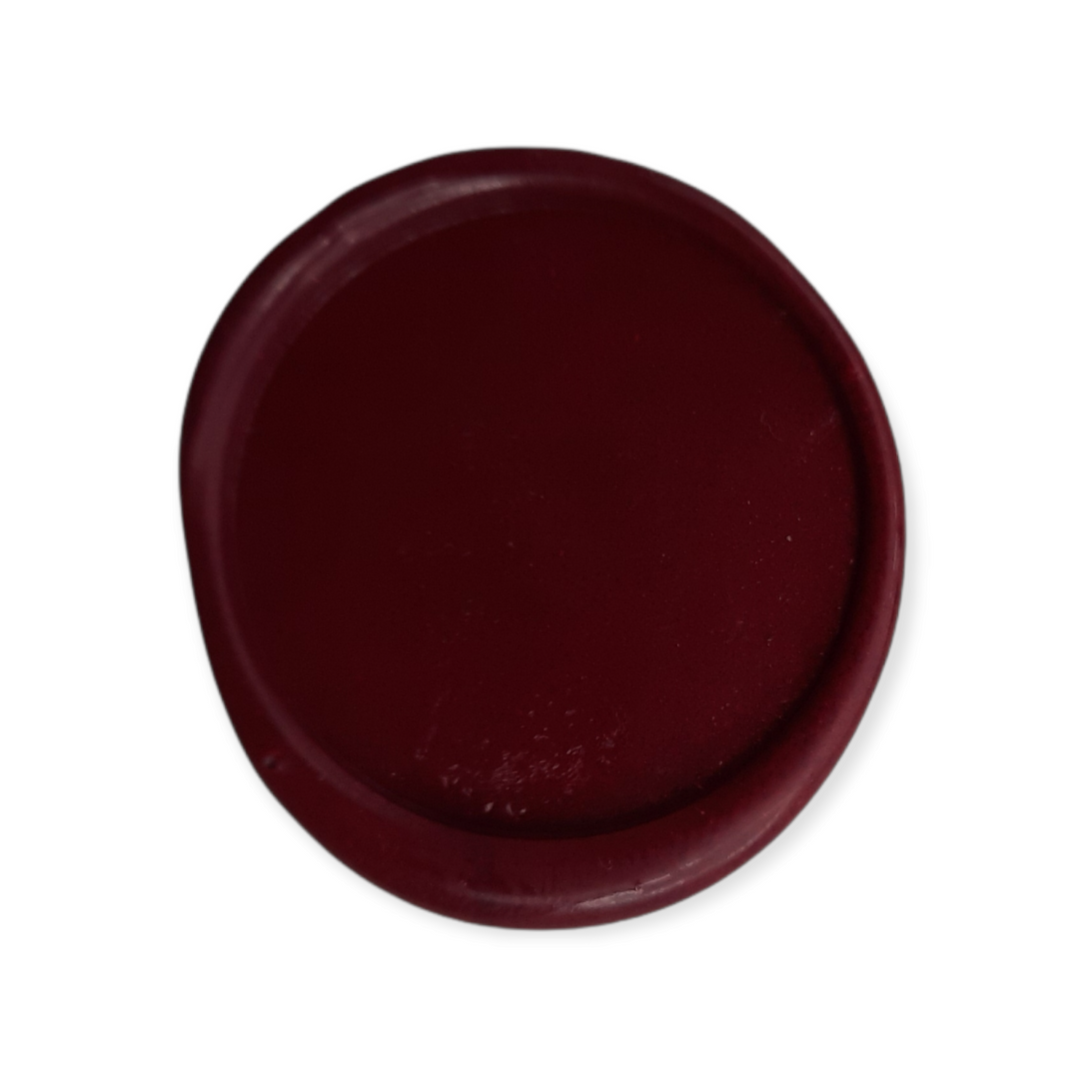 Burgundy wax seal impression showcasing smooth texture and rich color. Perfect for secure and decorative sealing needs.