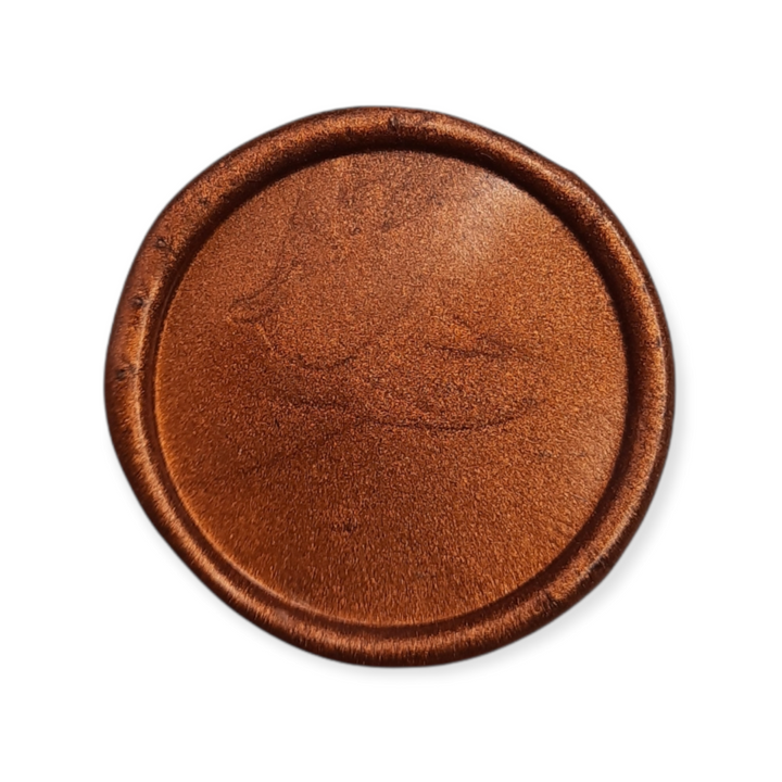 Close-up of a copper wax seal with a smooth, metallic finish and intricate design. Ideal for professional and decorative sealing applications.