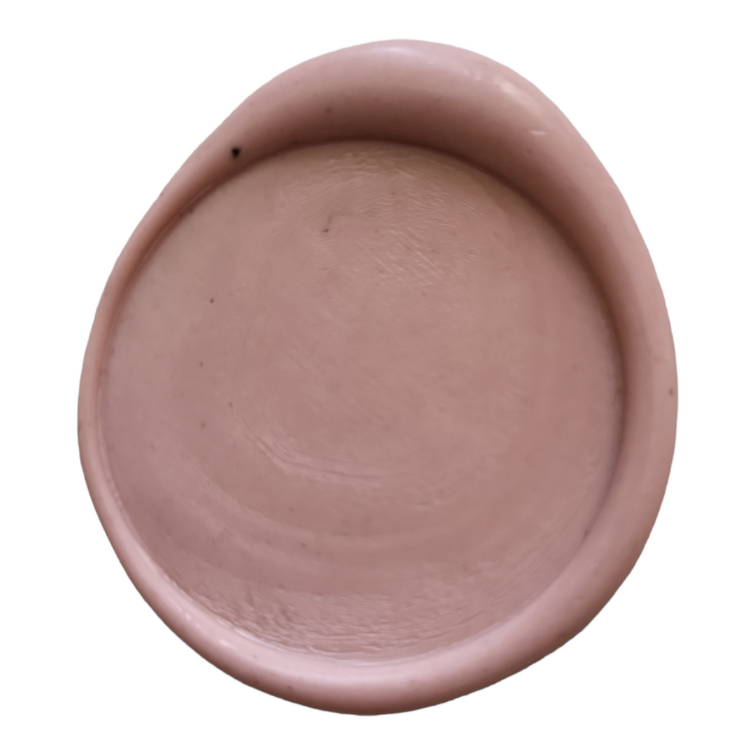 Close-up of a dusty rose wax seal with a smooth finish, perfect for sealing letters and decorative crafts.