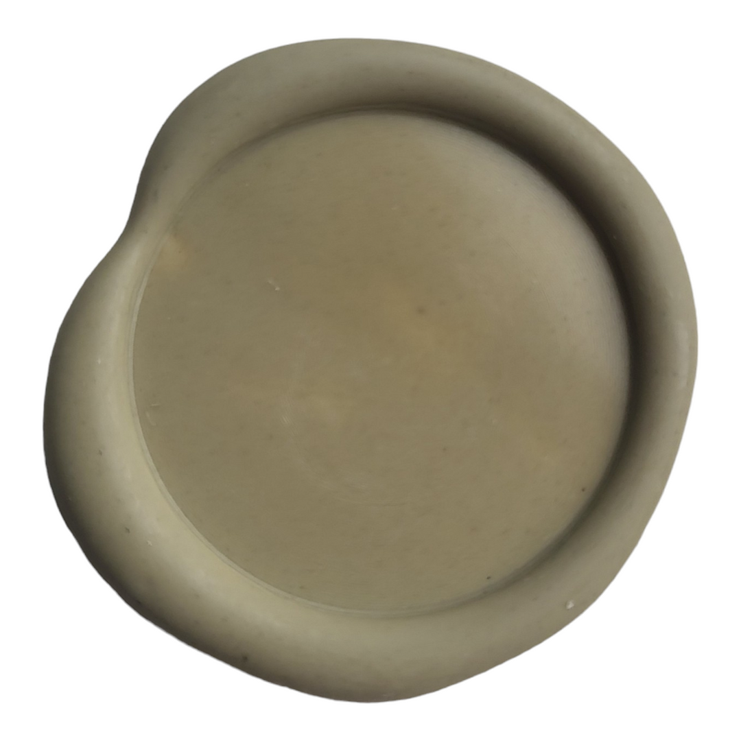 Close-up of a pistachio-colored wax seal with a smooth, rounded finish, perfect for decorative sealing purposes.