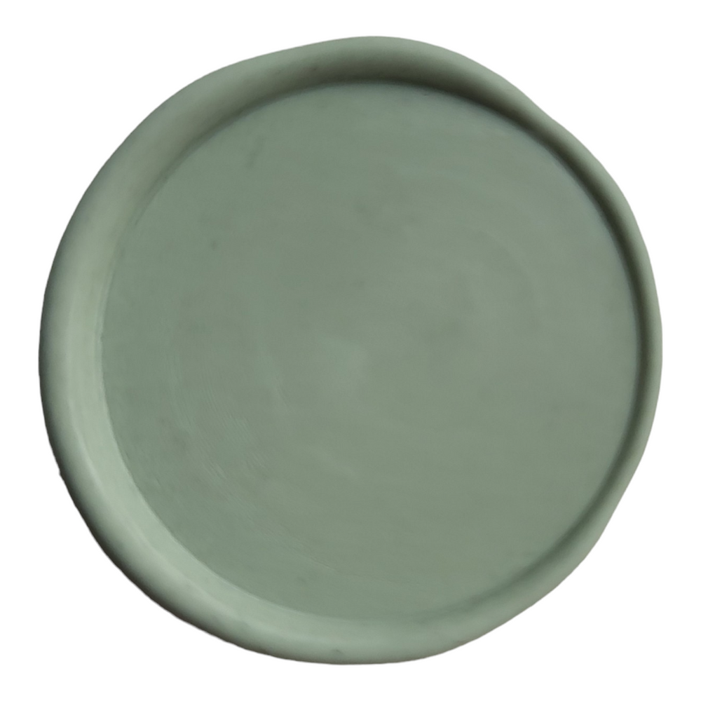 Close-up of a sage green wax seal showcasing a smooth, handcrafted finish. Perfect for sealing letters and crafts.