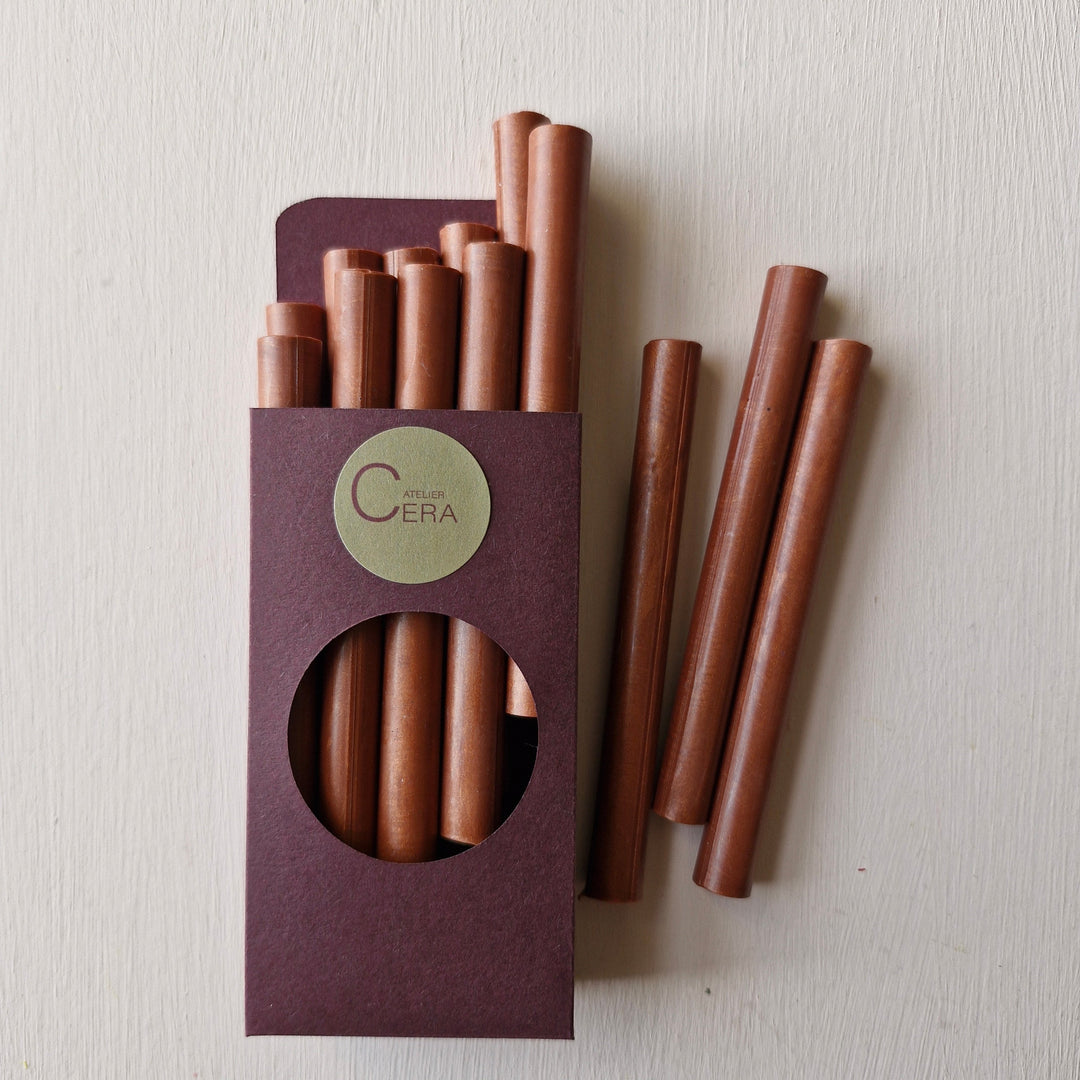 10 pack of copper sealing wax sticks in a maroon box with a circular cutout, ideal for creating elegant seals on invitations or branding.