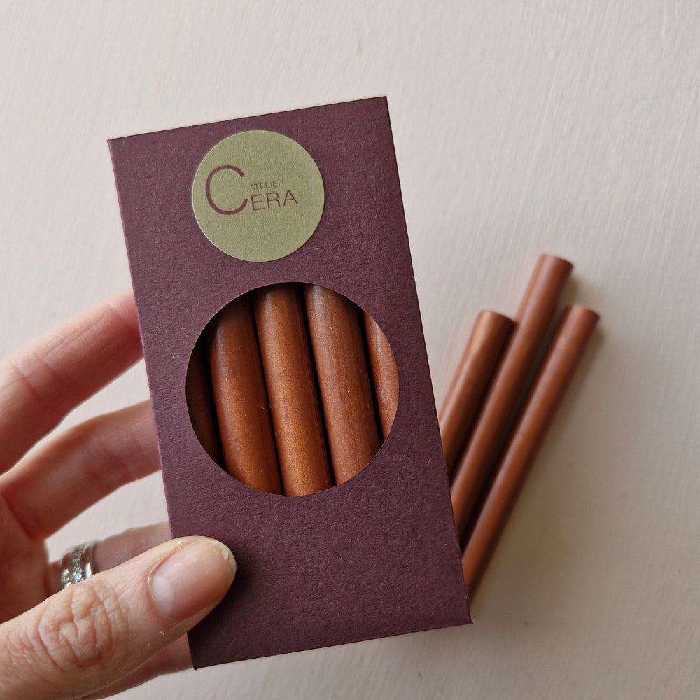 10 pack of copper sealing wax sticks in a burgundy box with a circular window, ideal for creating elegant seals for invitations or branding.