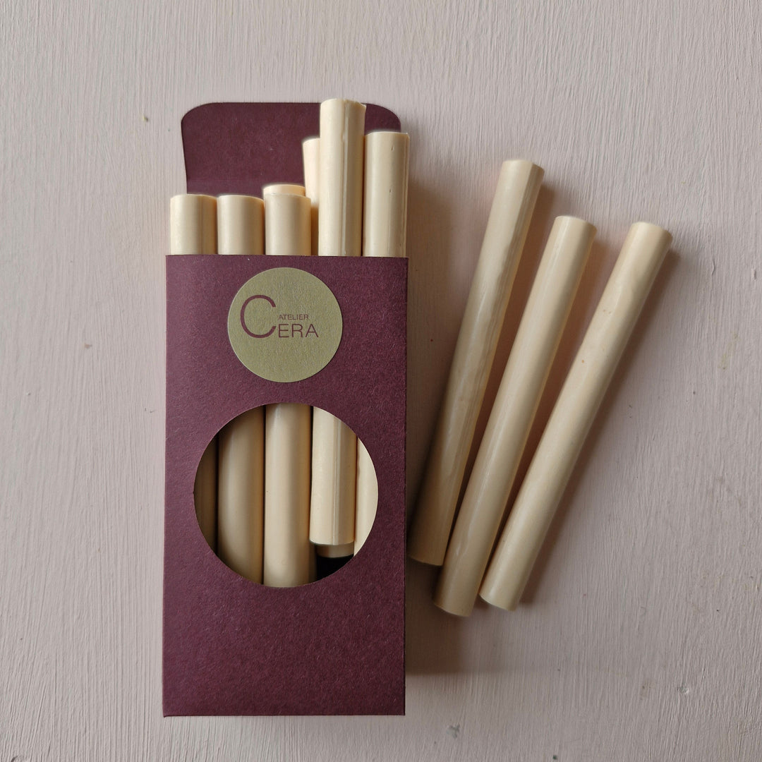 Pack of 10 soft peach sealing wax sticks, 11mm handmade, displayed in a burgundy box with a circular cutout. Ideal for wax seals in weddings or branding.