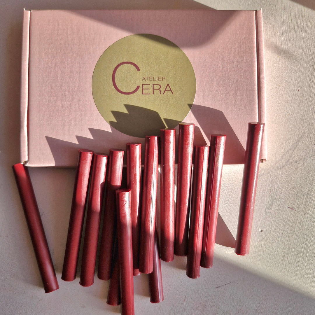 Box of 250 cherry red 11mm sealing wax sticks with several sticks displayed outside. Ideal for secure seals and compatible with wax guns.