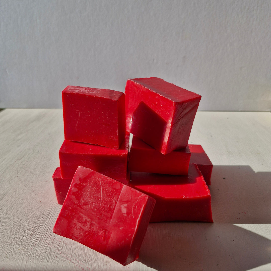 Raspberry Red bottle sealing wax blocks stacked on a white surface, ideal for crafting and sealing projects.