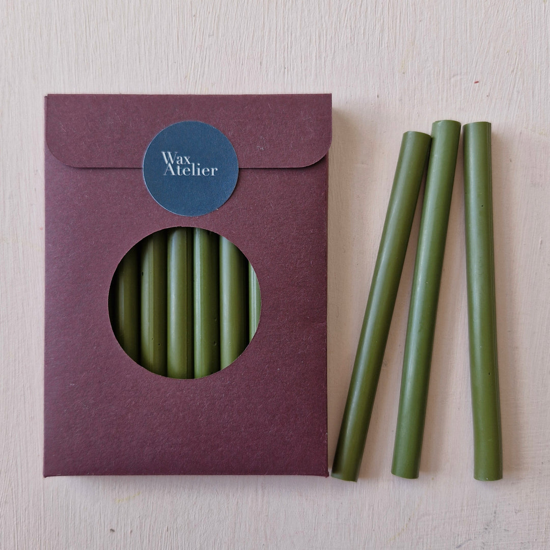 Pack of 10 olive green sealing wax sticks, 7mm thick, ideal for 50 seals. Handmade in Britain, perfect for envelopes, invitations, and crafts.