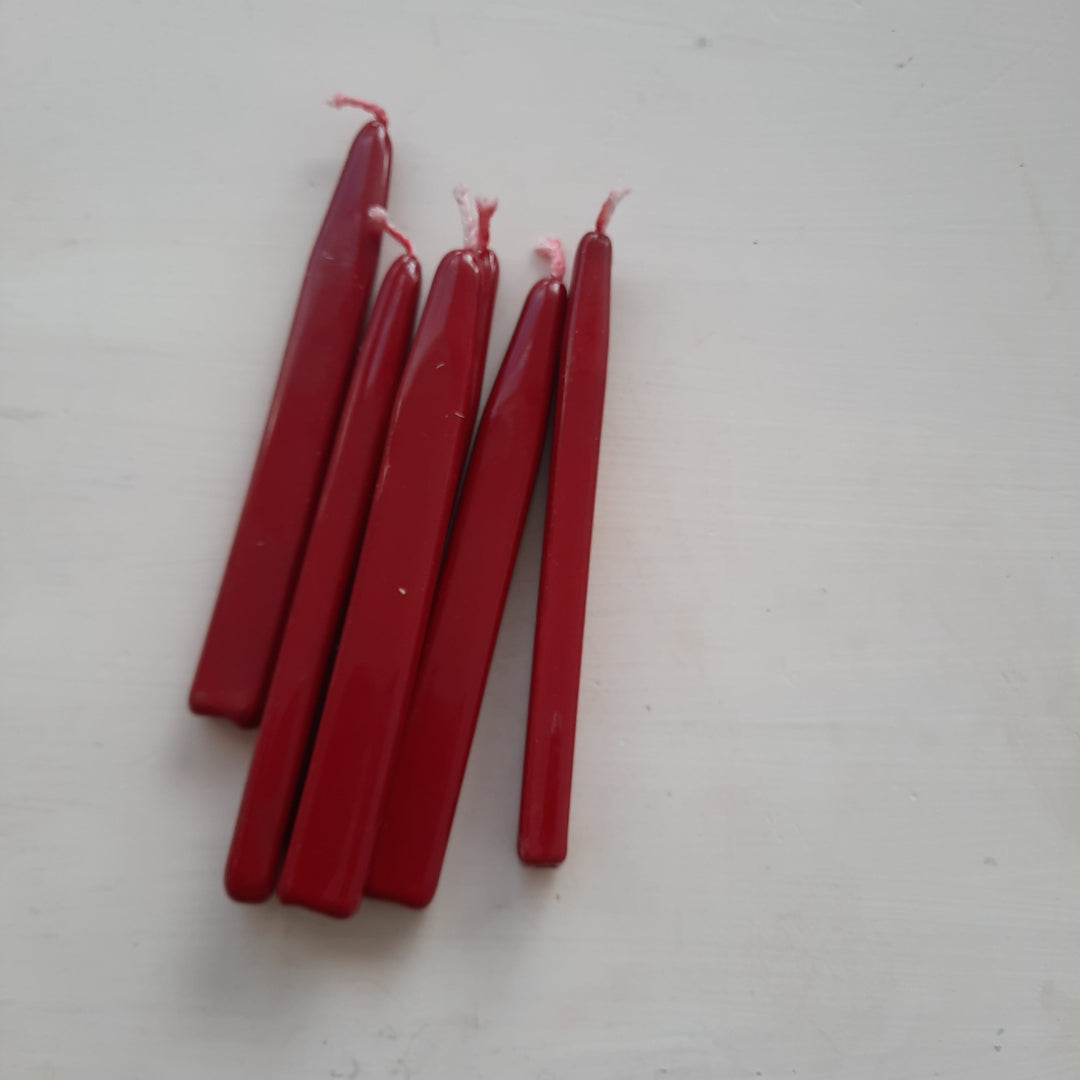 Set of red sealing wick wax sticks with pink wicks displayed on a white surface. Handmade in Britain for traditional seals.