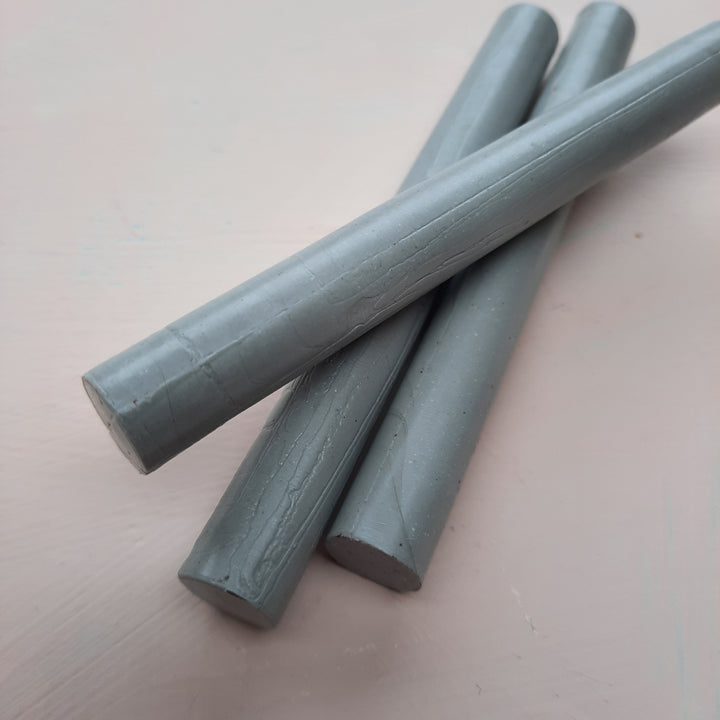 Three 11mm mid grey flexible sealing wax sticks for DIY projects, ideal for creating seals with a hotmelt glue gun at 105-110°C.